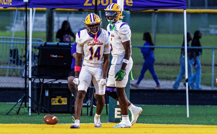 Columbia receiver Zion Walker (14) celebrates alongside Jaylon Willis after scoring on a 65-yard catch-and-run against Ed White on Friday. (JAMARION WEST/Special to the Reporter)