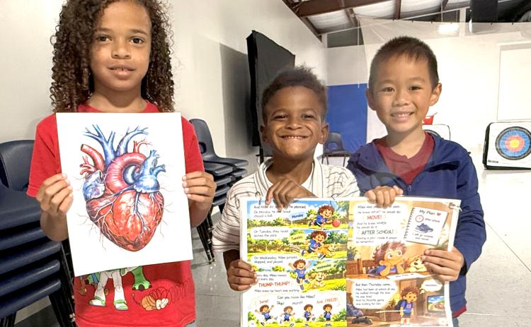 Westside Elementary School students proudly display illustrations used during October’s Choose to Move lesson, including an anatomical heart and pages from Miles Has a Plan! The hands-on learning experience helped students better understand how their hearts work and how planning for daily physical activity supports lifelong health. (COURTESY COLUMBIA COUNTY EXTENSION)