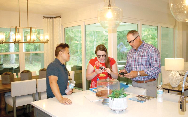 Scott Samera (from left) and Danielle Samera talk home floor plans and options with Bryan Zecher during a previous Parade of Homes event. (FILE)
