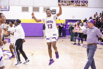 Columbia guard Tray Tolliver celebrates after defeating Daytona Beach Mainland 70-65 in Friday night’s Region 1-6A final. (BRENT KUYKENDALL/Lake City Reporter)