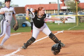 Columbia catcher Reece Chasteen fields a bunt and throws to first base in a game against Middleburg last season. Chasteen, along with third baseman Morgan Hoyle (left) are two of the Lady Tigers’ returning starters this season. (JEN CHASTEEN/Special to the Reporter)