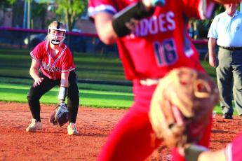 Hailey Clemons gets in her stance playing first base for Fort White during last season’s district tournament against Bradford. (FILE)