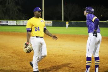 Columbia first baseman Daylon Lumpkin talks to Lance Minson after Minson reached first base safely during the Purple & Gold scrimmage Friday night. (JORDAN KROEGER/Lake City Reporter)