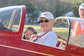 Mark Wiencek and Symphony Green, 8, get ready to take off from Cannon Creek Airpark and fly over Lake City as part of the Experimental Aircraft Association’s Young Eagles Rally on Saturday. (AMY HIETT/Special to the Reporter)