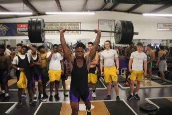 Columbia’s Marlon Pollock performs the clean and jerk during Wednesday’s tri-meet against Fleming Island and Baker County. (JORDAN KROEGER/Lake City Reporter)