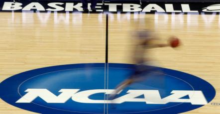 A player runs across the NCAA logo during practice at the NCAA tournament on In this March 14, 2012, in Pittsburgh. (AP FILE PHOTO)