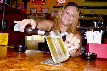 April Rhoden pours a cold one at R Bar on Wednesday afternoon. Since Friday, the bar — along with others in Lake City and throughout the state — has been allowed to serve beer again. (CARL MCKINNEY/Lake City Reporter)