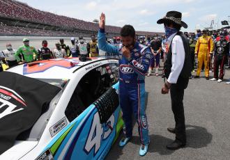 Bubba Wallace, driver of the #43 Victory Junction Chevrolet, and NASCAR Hall of Famer and team owner Richard Petty look on after NASCAR drivers pushed Wallace to the front of the grid as a sign of solidarity with the driver prior to the NASCAR Cup Series GEICO 500 at Talladega Superspeedway on Monday in Talladega, Ala. (CHRIS GRAYTHEN/Getty Images/TNS)