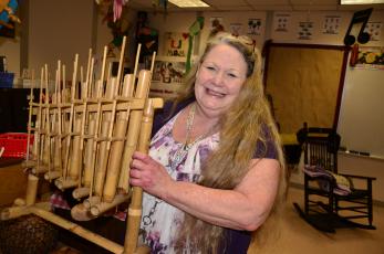 Eastside Elementary music teacher Teresa Cameron holds an angklung, an instrument originating in India. Cameron brought a large collection of world instruments with her when she joined Eastside 13 years ago. (CARL MCKINNEY/Lake City Reporter)