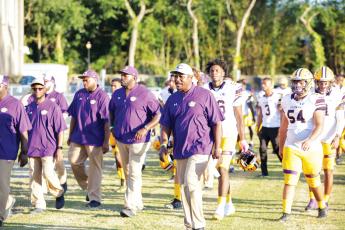 Columbia coach Brian Allen leads his team onto the field prior to last season’s game against Oakleaf. (FILE)