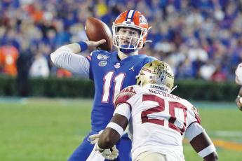 Florida quarterback Kyle Trask (11) throws a pass over Florida State linebacker Kalen DeLoach (20) during the first half of last year's game in Gainesville. (AP FILE PHOTO))