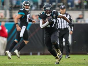 Jacksonville Jaguars running back Leonard Fournette (27) runs for a first down during the first half of an NFL football game against the Los Angeles Chargers at TIAA Bank Field, Sunday, Dec. 8, 2019 in Jacksonville. (TRIBUNE NEWS SERVICE)