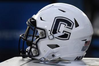 A Connecticut football helmet rests on the sideline during an NCAA college football game on Sept. 7, 2019, in East Hartford, Conn. UConn has canceled its 2020-2021 football season, becoming the first FBS program to suspend football because of the coronavirus pandemic. (AP FILE PHOTO)