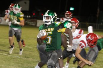 Suwannee defensive back Terrell Atkinson races down the sideline on an interception return for a touchdown on the final play of the first half Friday night against Bradford at Langford Stadium. (PAUL BUCHANAN/Special to the Reporter)