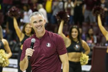 Florida State’s new head coach Mike Norvell smiles after being introduced during halftime of a basketball game against Clemson on Dec. 8, 2019, in Tallahassee. (AP FILE PHOTO)