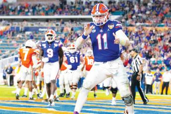 Florida Gators quarterback Kyle Trask (11) reacts after scoring on a two-point conversion late in the fourth quarter against the Virginia Cavaliers during the Capital One Orange Bowl at Hard Rock Stadium on Dec. 30, 2019, in Miami. (AL DIAZ/Miami Herald/TNS)