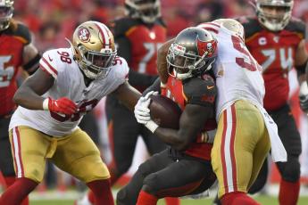 Tampa Bay Buccaneers running back Dare Ogunbowale (44) is tackled by San Francisco 49ers middle linebacker Fred Warner (54) in the fourth quarter on Sunday, Sept. 8, 2019 at Raymond James Stadium in Tampa. (ALLIE GOULDING/Tampa Bay Times/TNS)