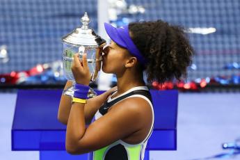 Naomi Osaka kisses the trophy in celebration after winning her Women's Singles final match against Victoria Azarenka of Belarus on Day thirteen of the 2020 U.S. Open at the USTA Billie Jean King National Tennis Center on Saturday in the Queens borough of New York City. (MATTHEW STOCKMAN/Getty Images/TNS)