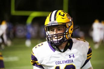 Columbia quarterback Ty Wehinger smiles coming off the field after throwing a touchdown pass last week against Trinity Christian. (BRENT KUYKENDALL/Lake City Reporter)