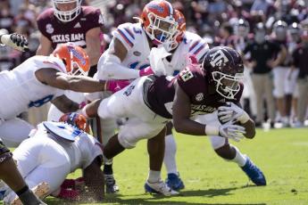 Texas A&M running back Isaiah Spiller (28) dives over the goal line for a touchdown against Florida on Saturday in College Station, Texas. (SAM CRAFT/Associated Press)