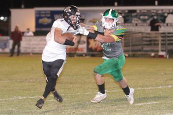Suwannee linebacker Blaine Howard tries to tackle Buchholz receiver Creed Whittemore last Friday. (PAUL BUCHANAN/Special to the Reporter)