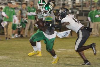 Suwannee quarterback Jaquez Moore scrambles up the field against Buchholz on Oct. 2. (PAUL BUCHANAN/Special to the Reporter)