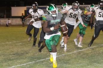 Suwannee quarterback Jaquez Moore scrambles up the field against Buchholz on Friday. (PAUL BUCHANAN/Special to the Reporter)