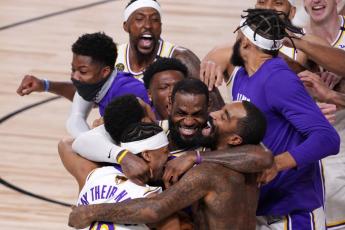 Los Angeles Lakers' LeBron James (23) celebrates with his teammates after the Lakers defeated the Miami Heat 106-93 in Game 6 of the NBA Finals on Sunday in Lake Buena Vista. (MARK J. TERRILL/Associated Press)