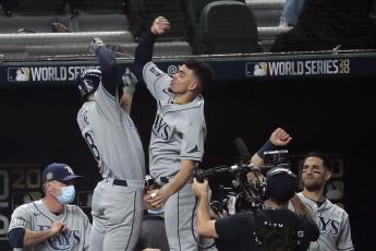 The Tampa Bay Rays' Brandon Lowe, top left, celebrates his first-inning solo home run with teammate Willy Adames in Game 2 of the World Series at Globe Life Field on Wednesday in Arlington, Texas. (ROBERT GAUTHIER/Los Angeles Times/TNS)