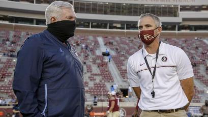 North Carolina coach Mack Brown, left, visits with Florida State coach Mike Norvell before the start of last weekend's game won by the Seminoles. (ACC POOL PHOTO)