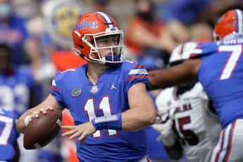 Florida quarterback Kyle Trask (11) throws a pass against South Carolina on Saturday in Gainesville. (JOHN RAOUX/Associated Press)
