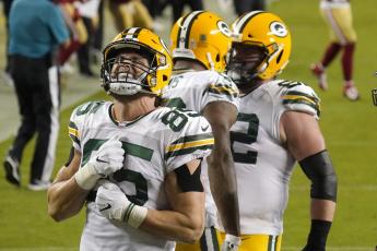 Green Bay Packers tight end Robert Tonyan (85) celebrates after tight end Marcedes Lewis, middle, scored a touchdown against the San Francisco 49ers on Nov. 5 in Santa Clara, Calif. (TONY AVELAR/Associated Press)