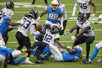 The Los Angeles Chargers' Tevaughn Campbell (37) forces the Jacksonville Jaguars' Dede Westbrook (12) to fumble on a second-half kick return at SoFi Stadium on Oct. 25 in Inglewood, California. The Chargers won, 39-29. (ALLEN J. SCHABEN/Los Angeles Times/TNS)