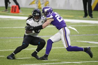 Jacksonville Jaguars wide receiver Laviska Shenault Jr. (10) tries to break a tackle by Minnesota Vikings safety Harrison Smith, right, after catching a pass on Sunday in Minneapolis. (BRUCE KLUCKHOHN/Associated Press)