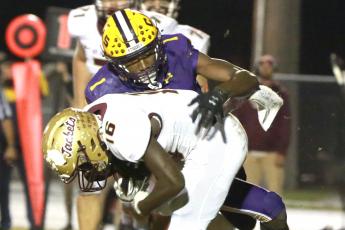 Columbia’s Shyheim Brown tackles St. Augustine running back Ty Baxter during Friday’s Region 1-6A final. (JEN CHASTEEN/Special to the Reporter)
