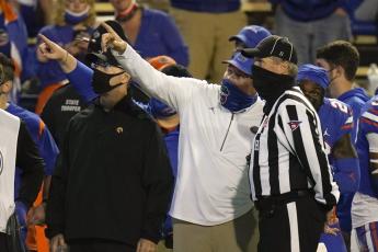 Florida coach Dan Mullen, center, points to the monitor while disputing a ruling by officials during Saturday's game against LSU in Gainesville. (JOHN RAOUX/Associated Press)