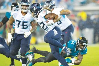 Tennessee Titans running back Derrick Henry (22) gets by Jacksonville Jaguars middle linebacker Myles Jack (44) in September of 2019 at TIAA Bank Field. (WILL DICKEY/TNS)