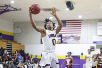 Columbia guard Dante Brown goes up for a shot against Madison County on Jan. 14. (BRENT KUYKENDALL/Lake City Reporter)