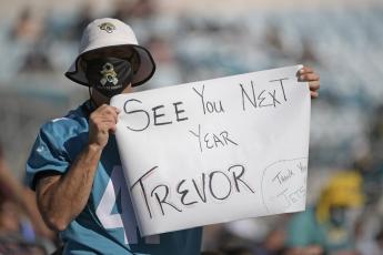 A Jacksonville Jaguars fan hold up a sign hoping that Clemson quarterback Trevor Lawerence will be the first pick for the Jacksonville Jaguars during a game against the Chicago Bears on Dec. 27, 2020, in Jacksonville. (PHELAN M. EBENHACK/Associated Press)