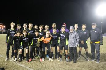 Columbia’s soccer team poses with the Three Rivers Cup after defeating Santa Fe 2-1 at home on Friday. (TONY BRITT/Lake City Reporter)