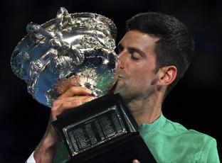 Novak Djokovic kisses the Norman Brookes Challenge Cup after defeating Daniil Medvedev in the men's singles final at the Australian Open on Sunday in Melbourne, Australia. (MARK DADSWELL/Associated Press)
