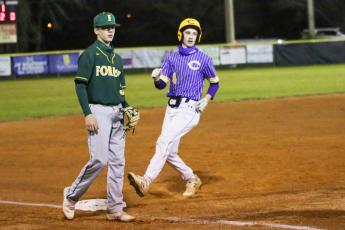 Columbia's Bryant Green strolls into third base against Forest on Thursday night. (BRENT KUYKENDALL/Lake City Reporter)