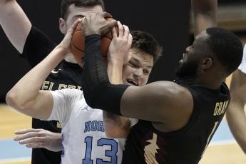 Florida State forward RaiQuan Gray (1) and North Carolina forward Walker Kessler (13) struggle for the ball during Saturday's game in Chapel Hill, N.C. (GERRY BROOME/Associated Press)