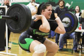 Suwannee’s Samantha Barber performs the clean and jerk during Friday’s Region 1-1A meet on Friday. Barber placed second in the unlimited class and received an at-large bid to state on Monday. (PAUL BUCHANAN/Special to the Reporter)