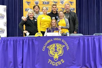 Columbia catcher and golfer Reece Chasteen (bottom middle) signed her letter of intent with Emory and Henry College on Monday to play both softball and golf. Chasteen is pictured with her mother Jen (from left), brother Milla, sister Kaicie, brother Moss, sister Emy and father Matt. (COURTESY)