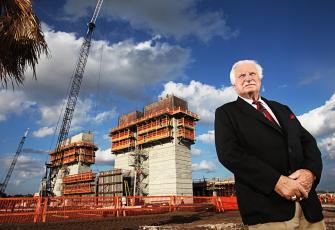 Then Florida Atlantic University football coach Howard Schnellenberger stands in front of the team's new stadium, which was under construction and is now named for him, in 2011. His building of the Owls football program as well as success at Miami and Louisville have earned him the Paul 'Bear' Bryant Lifetime Achievement Award. (POST FILE PHOTO/TNS)