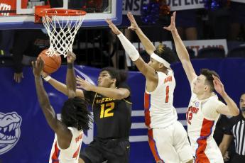 Missouri guard Dru Smith (12) goes up and under the basket to score the game-winning basket against Florida on Wednesday in Gainesville. (BRAD MCCLENNY McClenny/The Gainesville Sun via AP)
