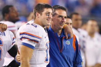 Florida quarterback Tim Tebow and head coach Urban Meyer share a moment together during a game against Georgia at Jacksonville Municipal Stadium on Nov. 1, 2008. (STEPHEN M. DOWELL/Orlando Sentinel/TNS)