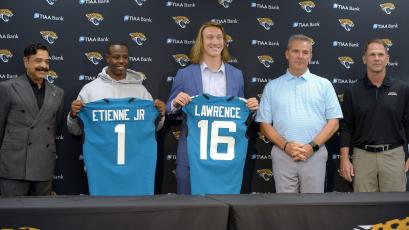 After his arrival in Jacksonville on April 30,  Jacksonville Jaguars first-round draft pick Trevor Lawrence, center, and running back Travis Etienne appear with team owner Shad Khan, left, head coach Urban Meyer and Jaguars general manager Trent Baalke at an introductory press conference at TIAA Bank Field. (BOB SELF/Florida Times-Union/TNS)