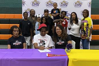 Columbia forward Charleston Ponds signs his letter of intent to play at Davis & Elkins College earlier this month. (COURTESY)